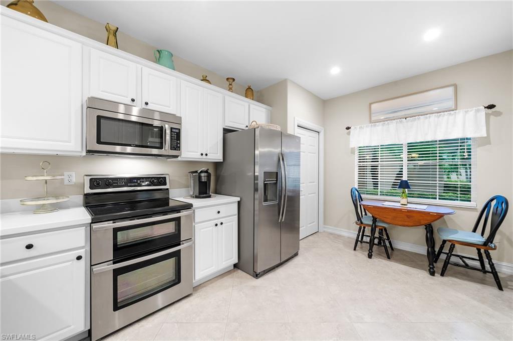 9128 Michael Circle, Unit 9 Naples, FL 34113 - Photo 24 of 50 Kitchen featuring stainless steel appliances, white cabinets, and light tile floors