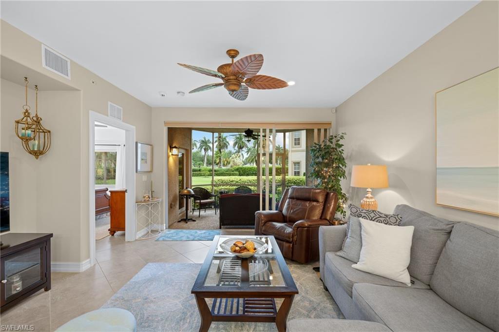 9128 Michael Circle, Unit 9 Naples, FL 34113 - Photo 5 of 50 Tiled living room with ceiling fan
