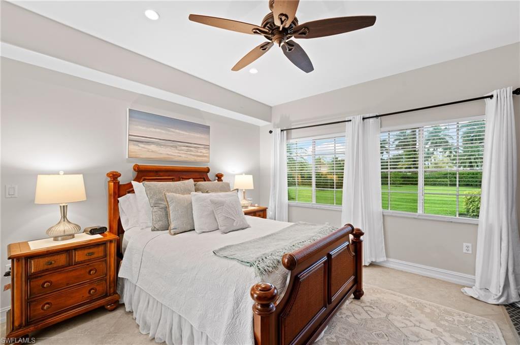 9128 Michael Circle, Unit 9 Naples, FL 34113 - Photo 10 of 50 Bedroom with ceiling fan and light tile floors