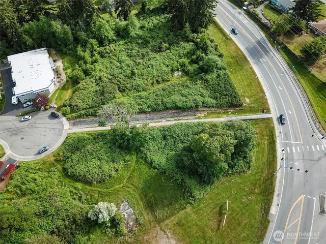 an aerial view of residential house with outdoor space and trees all around