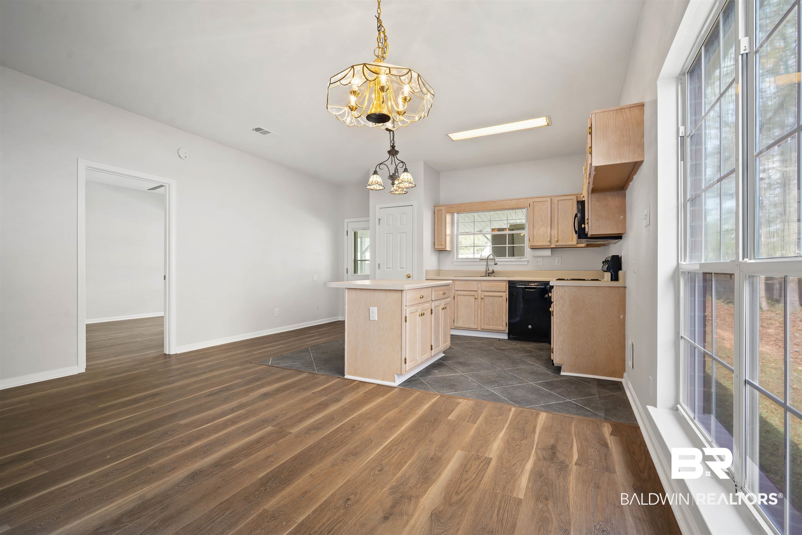 250 North Spring Lake Drive Mobile, AL 36695 - Photo 6 of 29 Kitchen featuring light brown cabinets, light countertops, a chandelier, dark wood-type flooring, and a center island