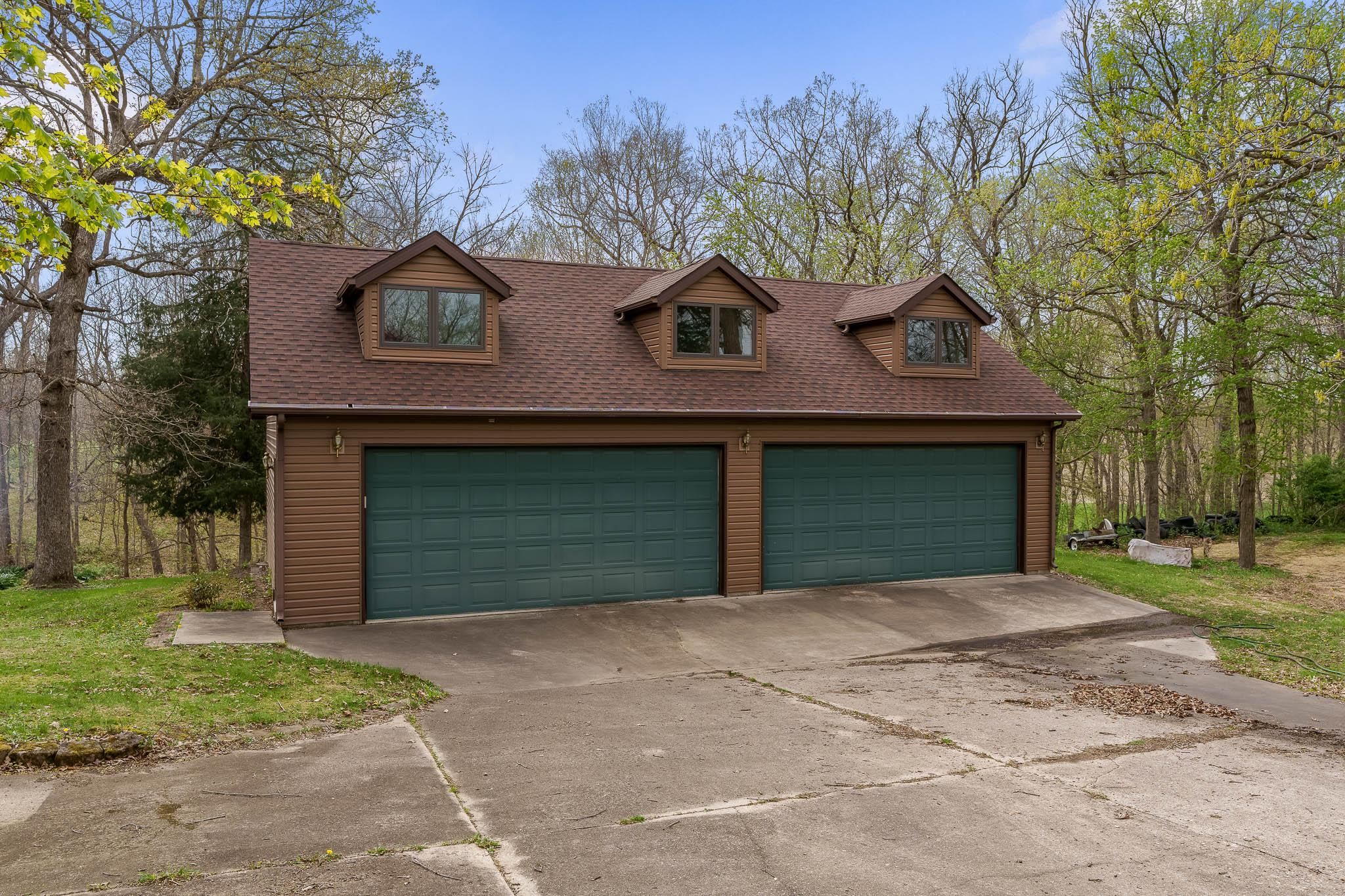 10446 North Davis Road Davis, IL 61019 - Photo 54 of 68 a front view of a house with a yard and garage