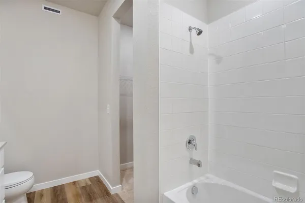 a bathroom with a tub and a toilet