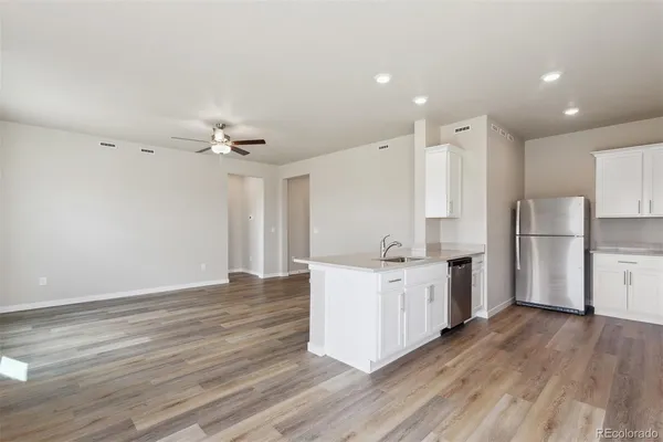 a kitchen with a sink and a refrigerator