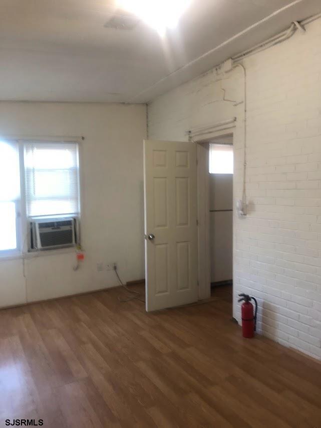 85-91 North Main Street, Unit A Pleasantville, NJ 08232 - Photo 3 of 10 an empty room with wooden floor and window
