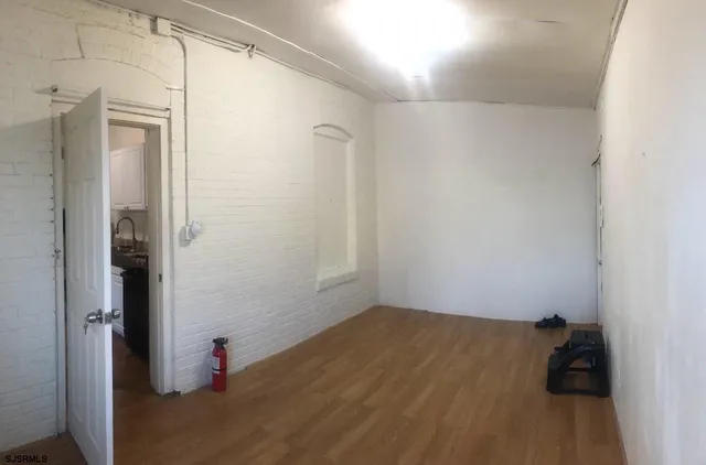 a view of a room with wooden floor and closet