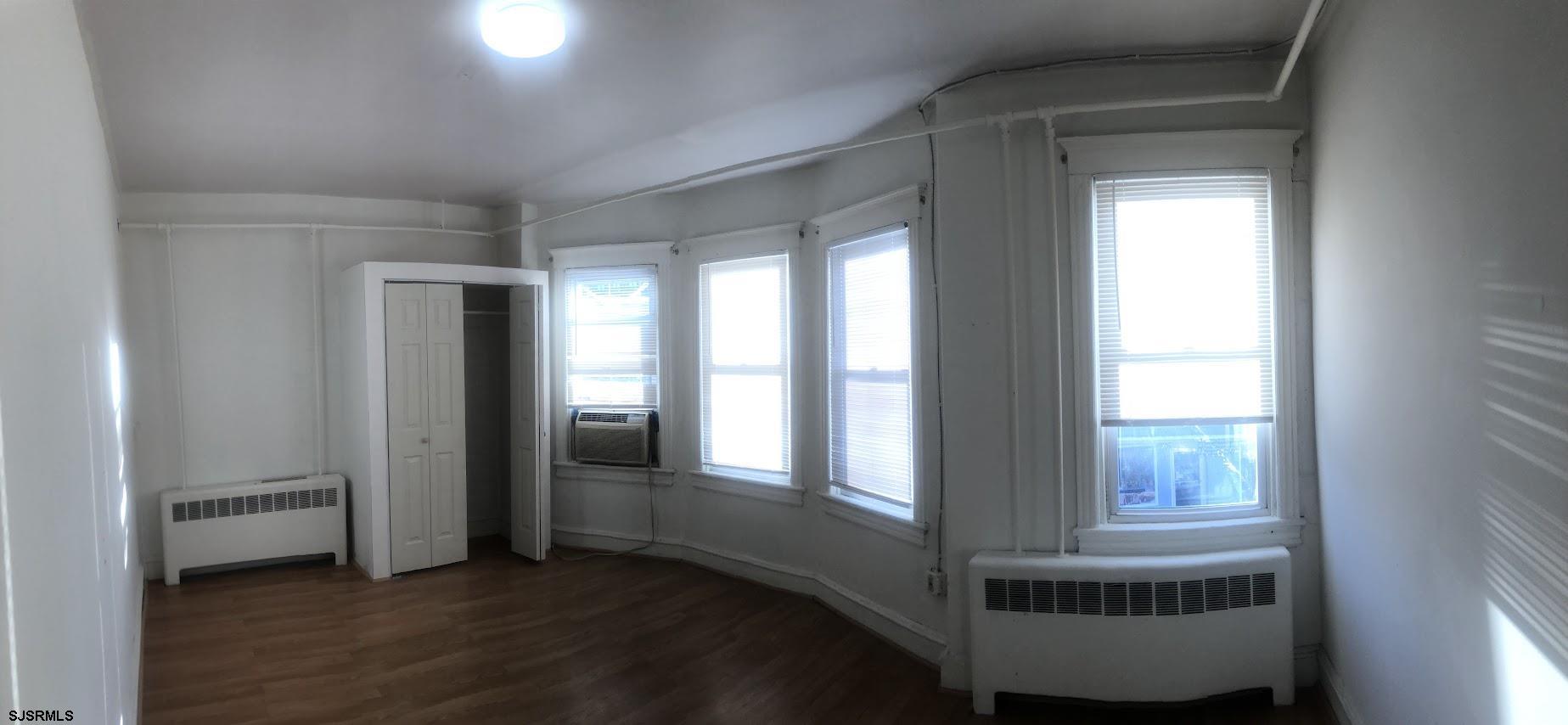 85-91 North Main Street, Unit A Pleasantville, NJ 08232 - Photo 6 of 10 a view of an empty room with glass door and windows