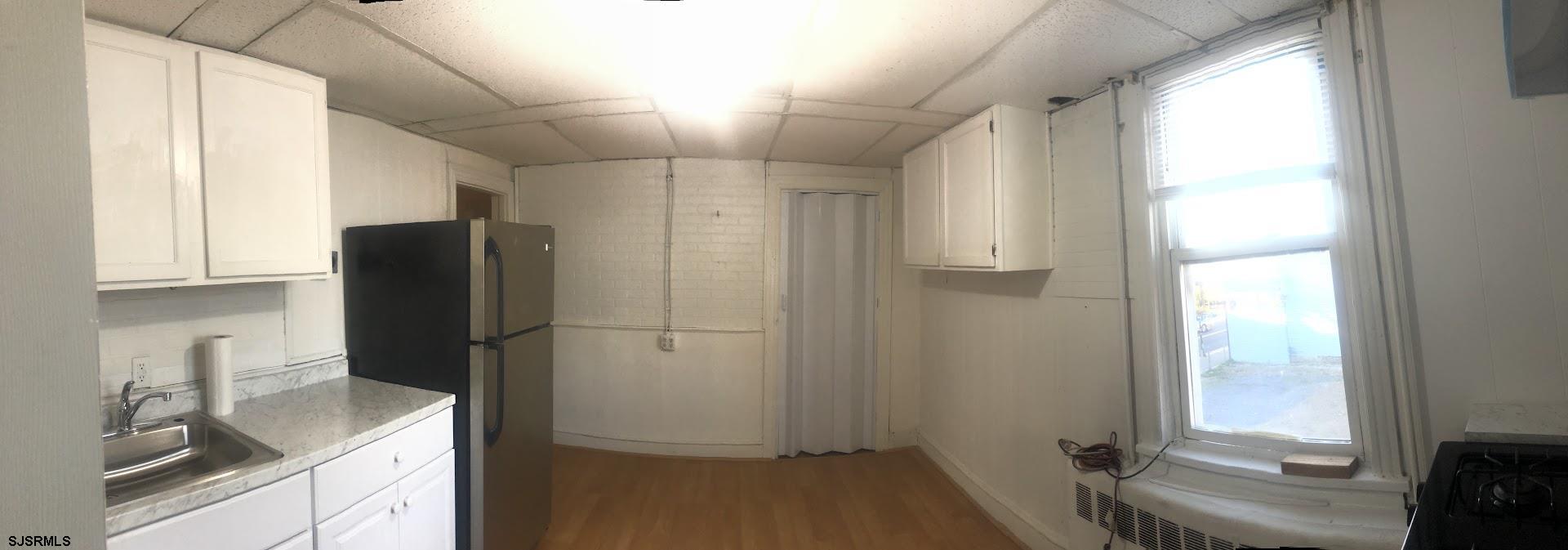 85-91 North Main Street, Unit A Pleasantville, NJ 08232 - Photo 8 of 10 a kitchen with a refrigerator and a sink