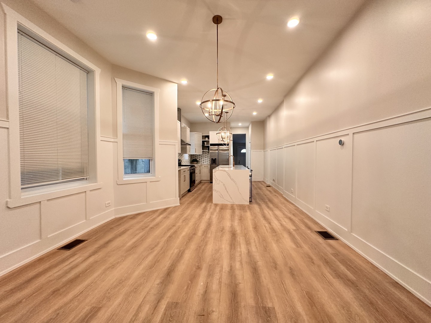 4409 South Prairie Avenue Chicago, IL 60653 - Photo 18 of 44 a view of a room with wooden floor white walls and windows