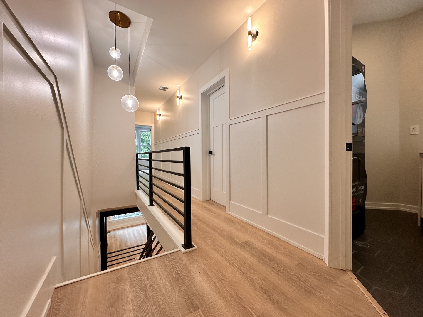 4409 South Prairie Avenue Chicago, IL 60653 - Photo 23 of 44 a view of a hallway with stairs and wooden floor