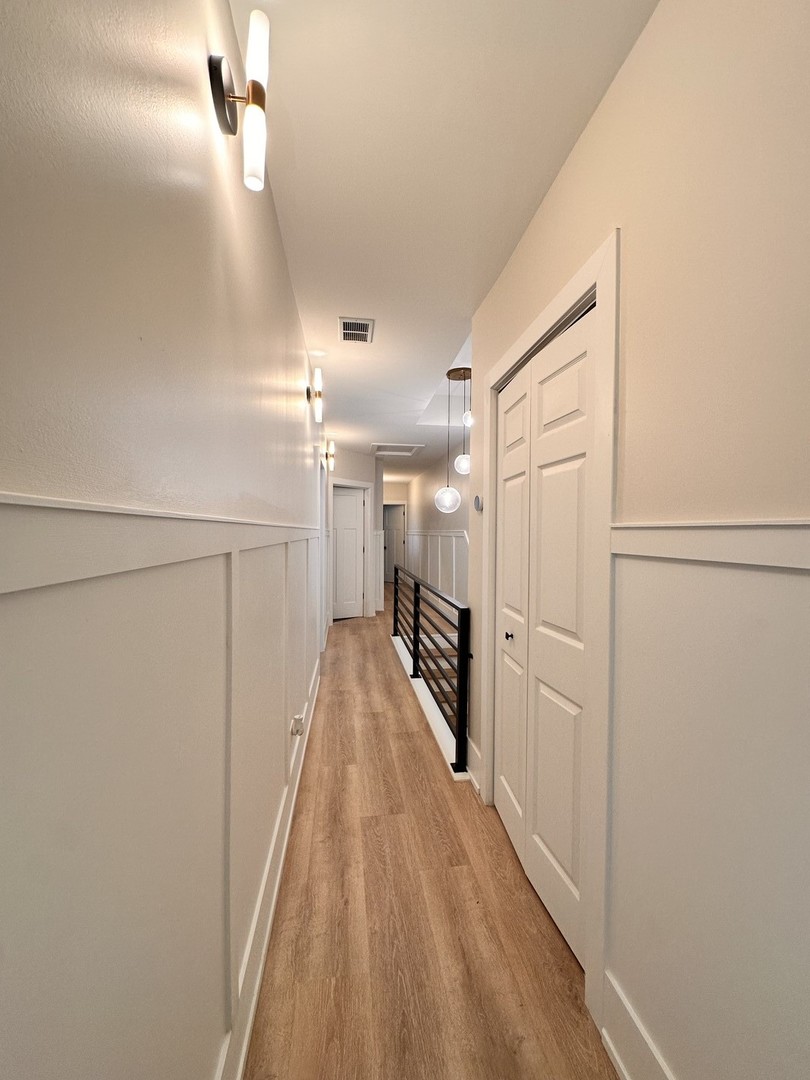4409 South Prairie Avenue Chicago, IL 60653 - Photo 29 of 44 a view of a hallway with wooden floor