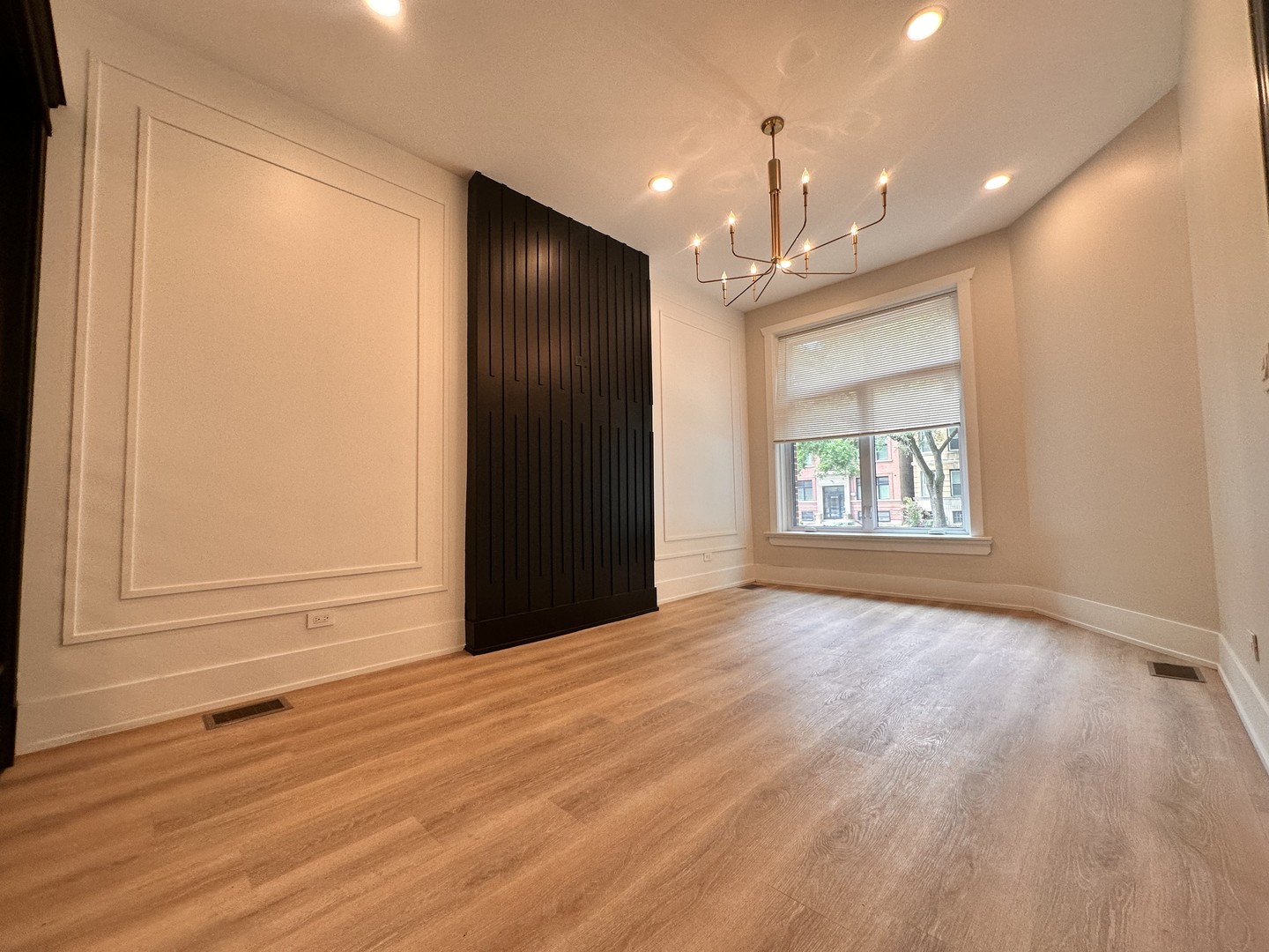 4409 South Prairie Avenue Chicago, IL 60653 - Photo 5 of 44 an empty room with wooden floor cabinet and windows