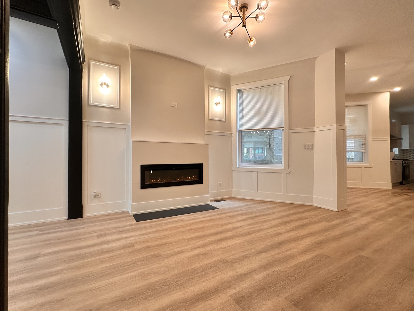 4409 South Prairie Avenue Chicago, IL 60653 - Photo 10 of 44 a view of an empty room with wooden floor fireplace and a window