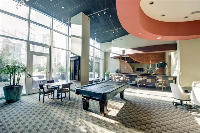 a living room with furniture a large window and a table