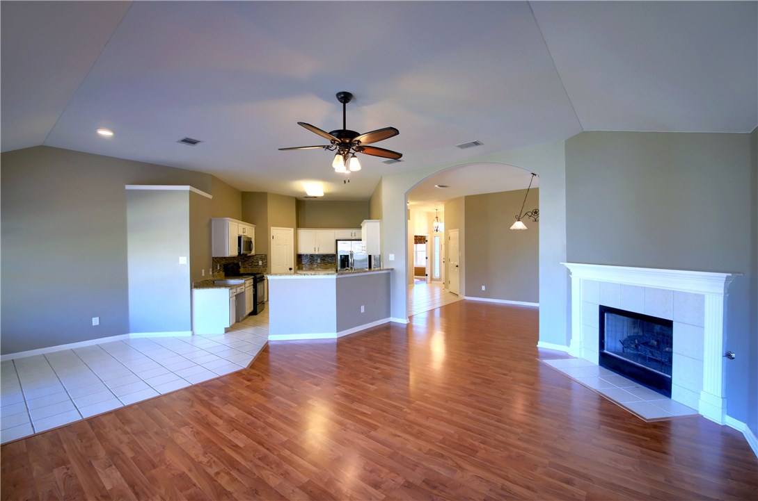 129 Copperwood Loop Round Rock, TX 78665 - Photo 11 of 30 a view of a kitchen with a sink and a fireplace