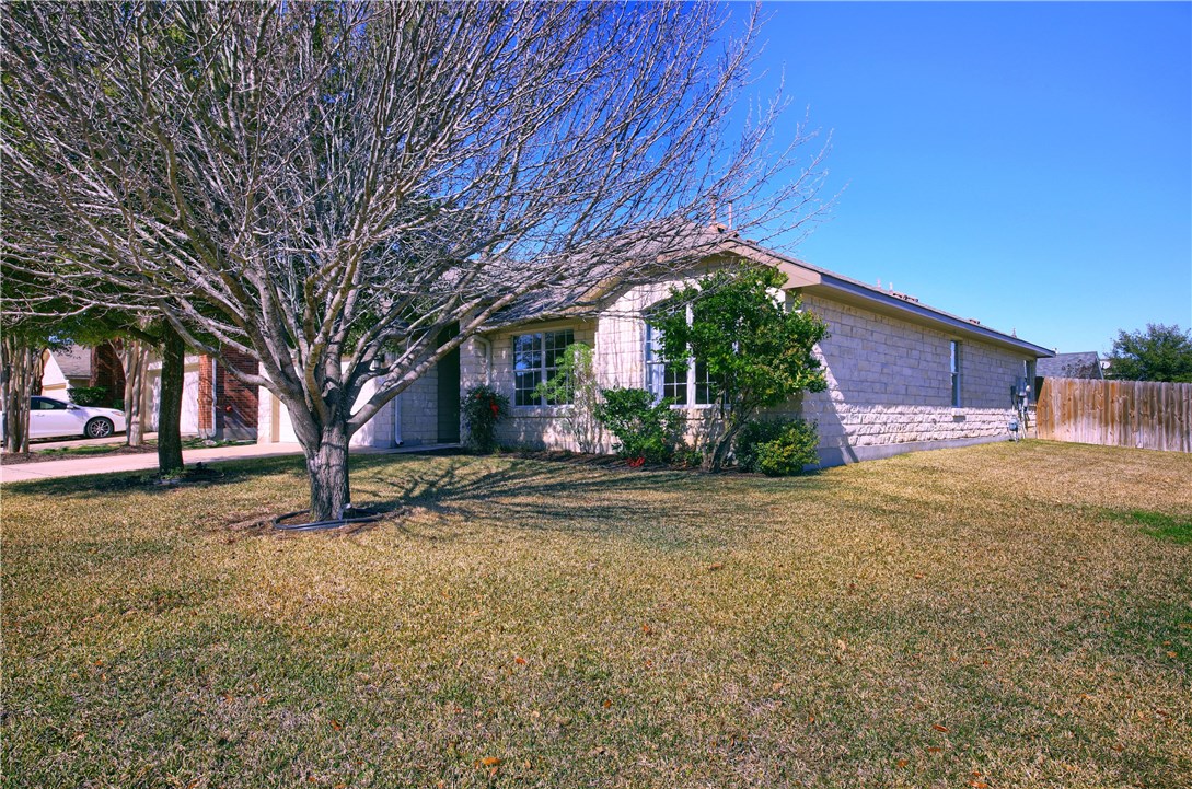 129 Copperwood Loop Round Rock, TX 78665 - Photo 2 of 30 a front view of a house with garden