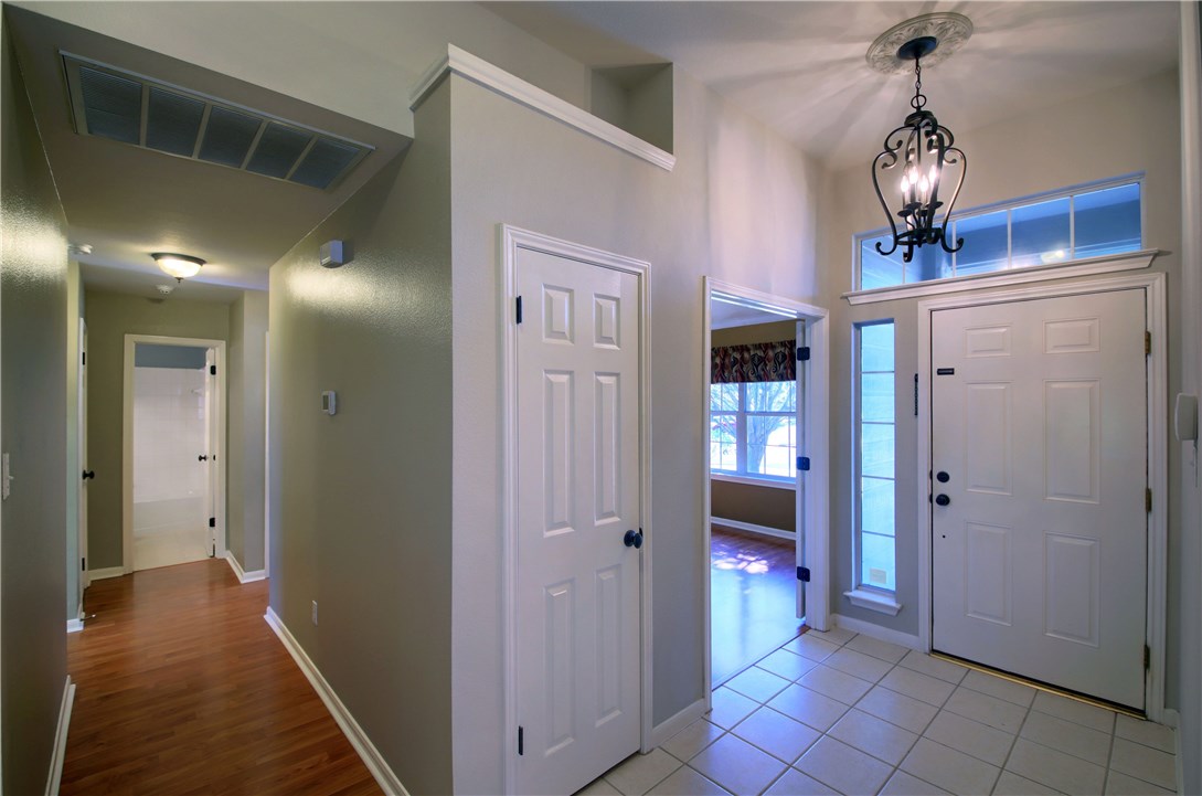 129 Copperwood Loop Round Rock, TX 78665 - Photo 7 of 30 a view of a hallway with wooden floor and entryway