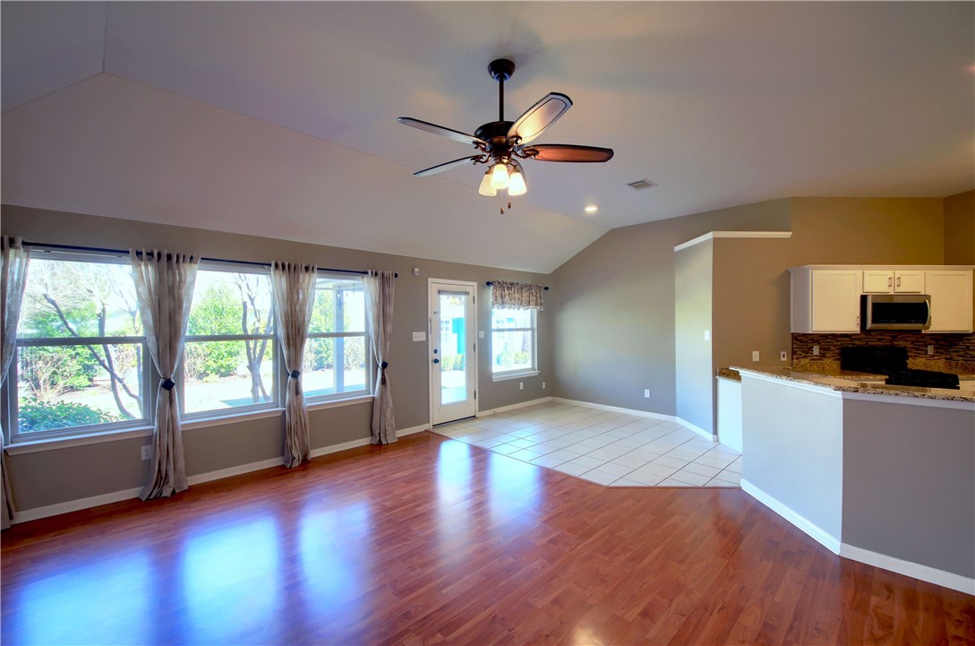 129 Copperwood Loop Round Rock, TX 78665 - Photo 10 of 30 a view of an empty room with window and wooden floor