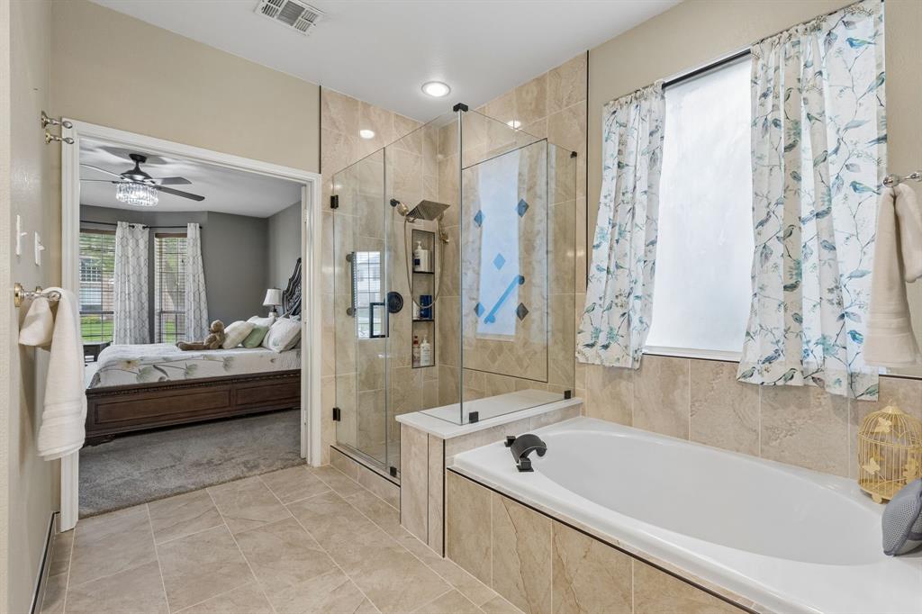 129 Timberbluff Lane Murphy, TX 75094 - Photo 21 of 34 a bathroom with a tub a sink and a shower