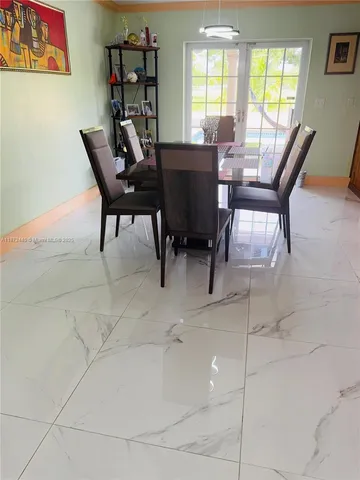 a view of a hallway with paintings on the wall