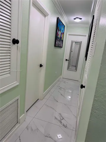 a view of a hallway with paintings on the wall