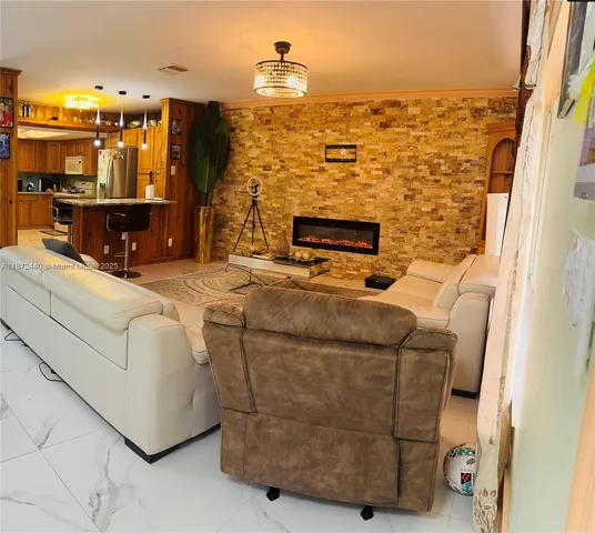 a living room with fireplace furniture and a flat screen tv