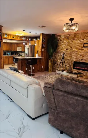 a kitchen with granite countertop a sink and a refrigerator