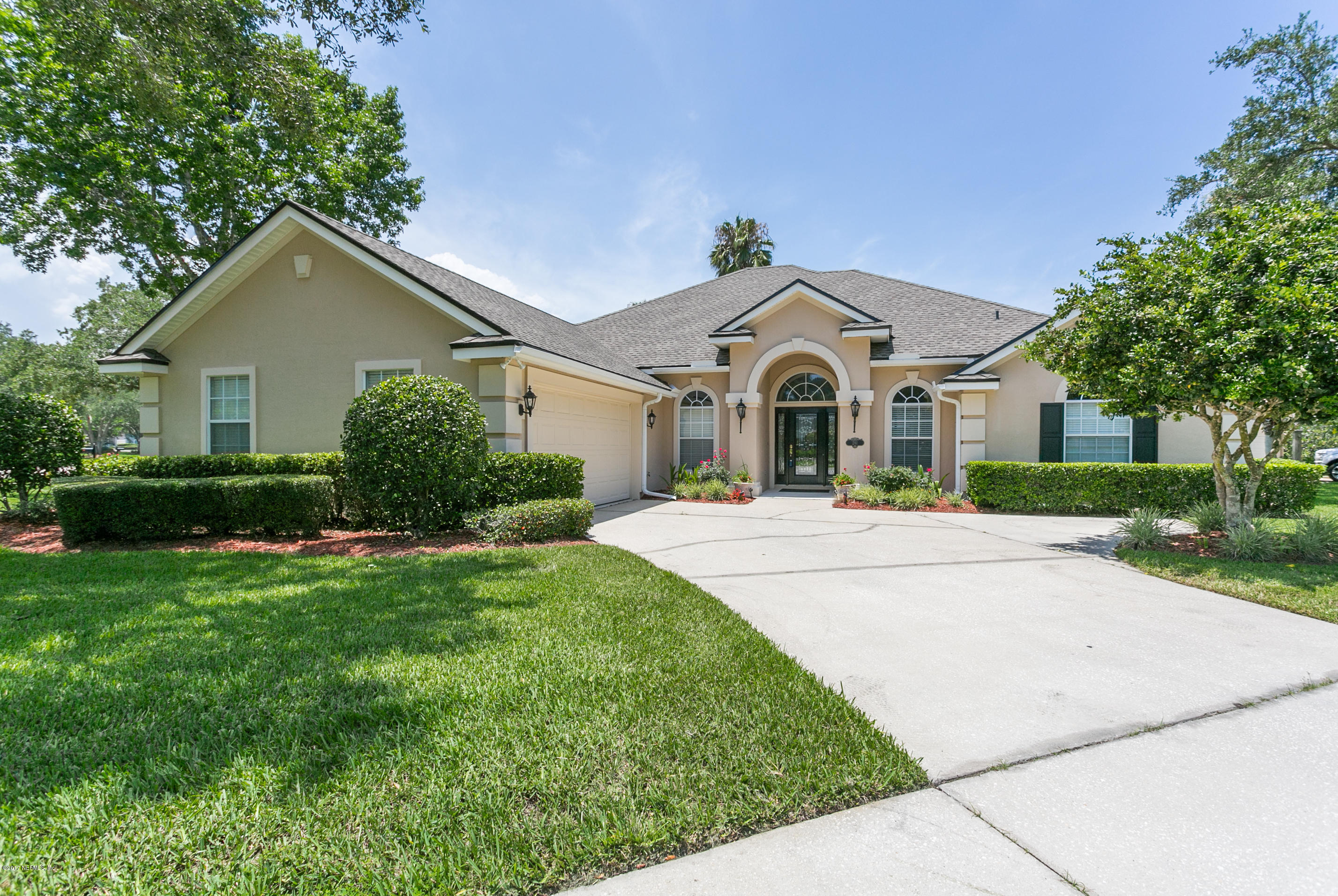 261 North Mill View Way Ponte Vedra Beach, FL 32082 - Photo 1 of 27 a front view of a house with a yard and trees