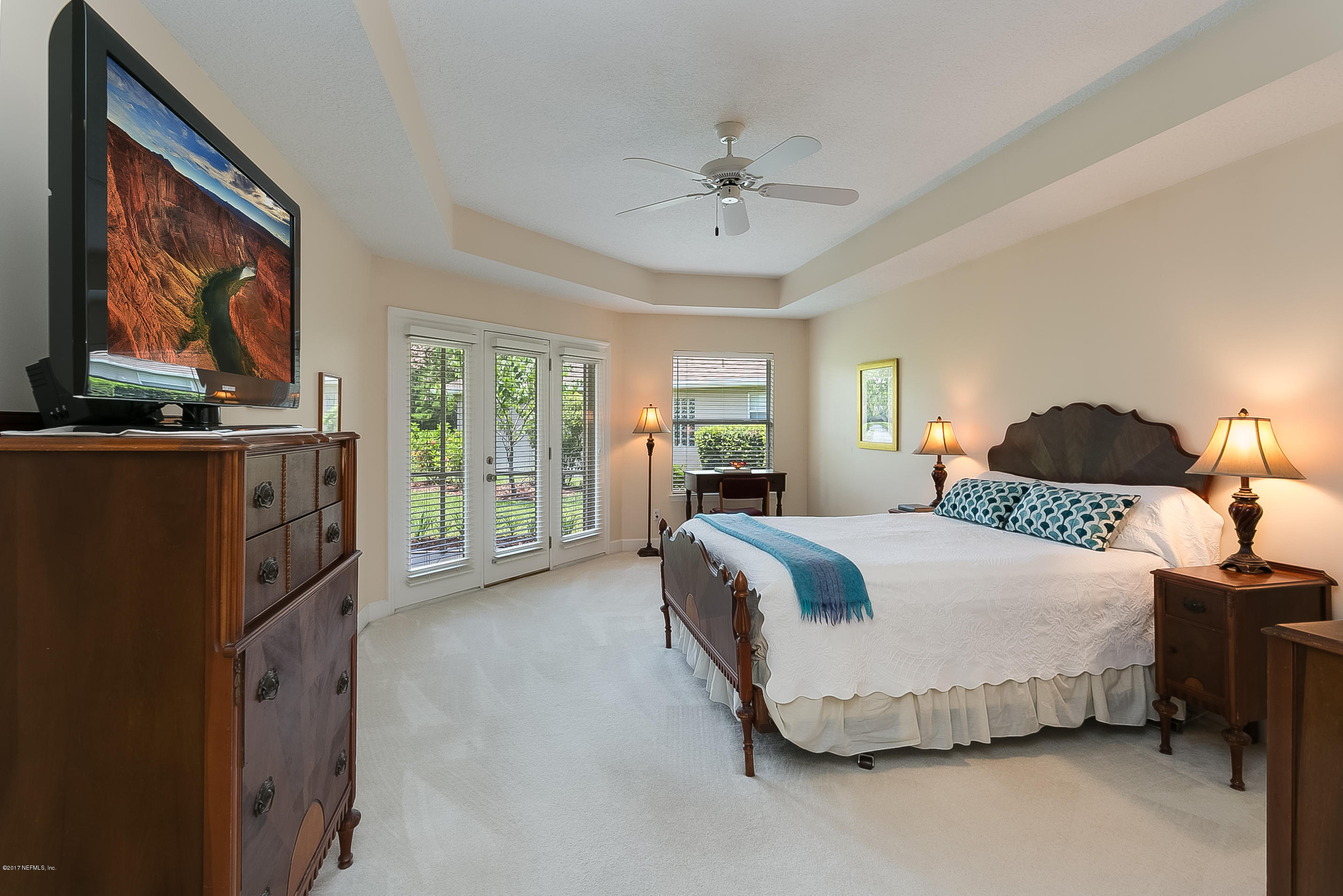 261 North Mill View Way Ponte Vedra Beach, FL 32082 - Photo 12 of 27 a spacious bedroom with a bed a dresser and next to a window