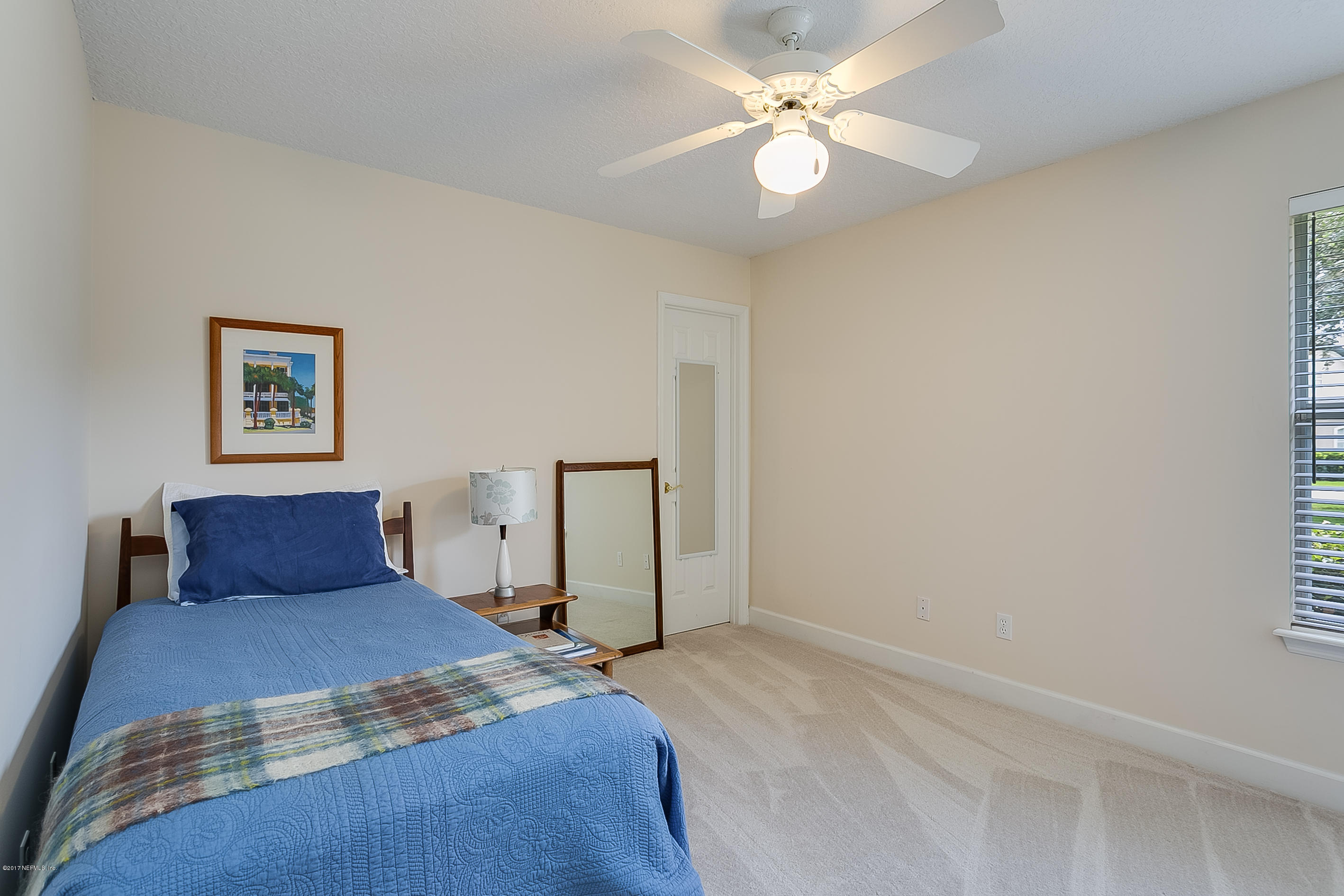 261 North Mill View Way Ponte Vedra Beach, FL 32082 - Photo 19 of 27 a bedroom with a large bed and a chandelier