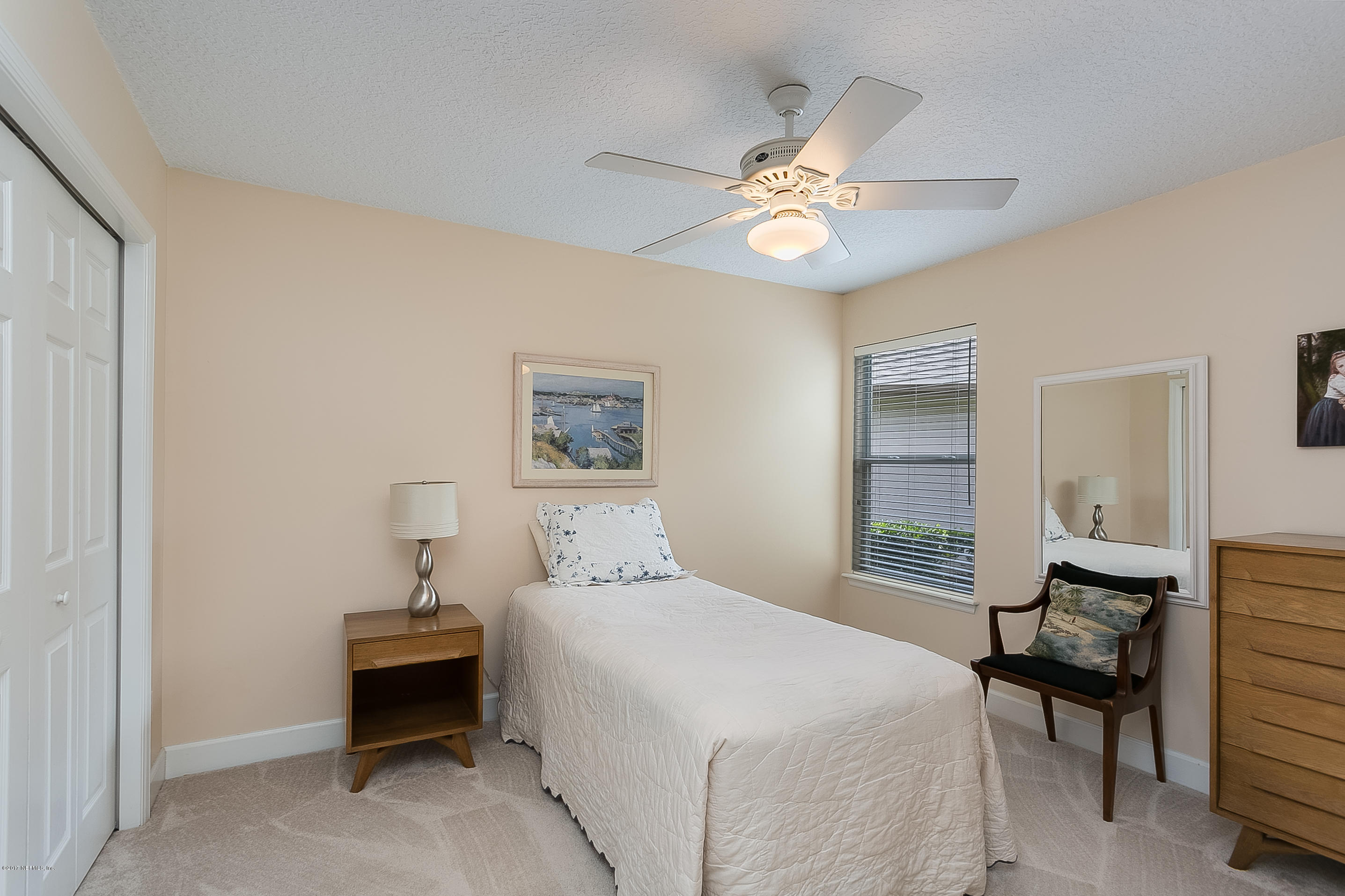261 North Mill View Way Ponte Vedra Beach, FL 32082 - Photo 20 of 27 a bedroom with a bed and a chandelier