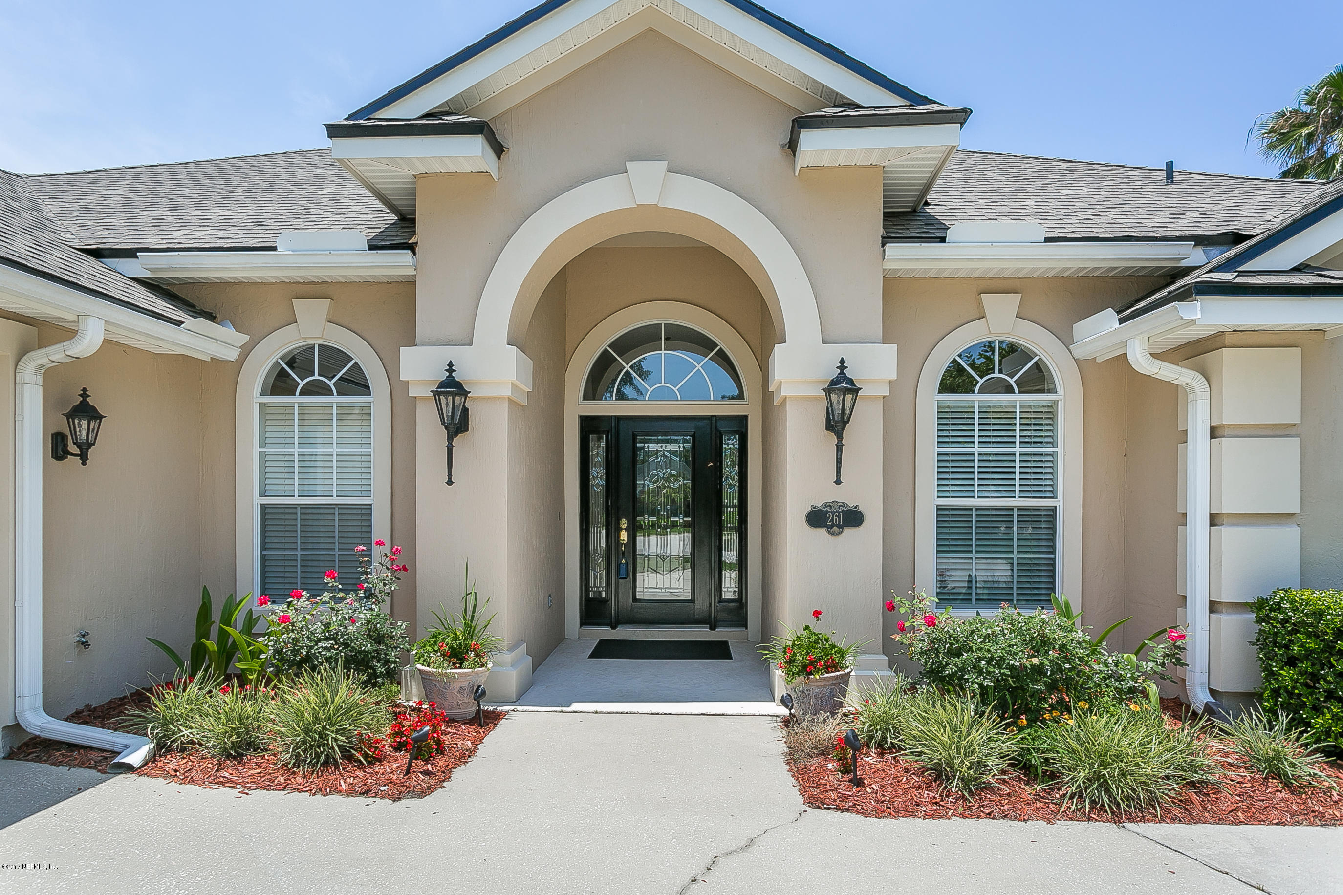 261 North Mill View Way Ponte Vedra Beach, FL 32082 - Photo 2 of 27 a front view of a house with a garden