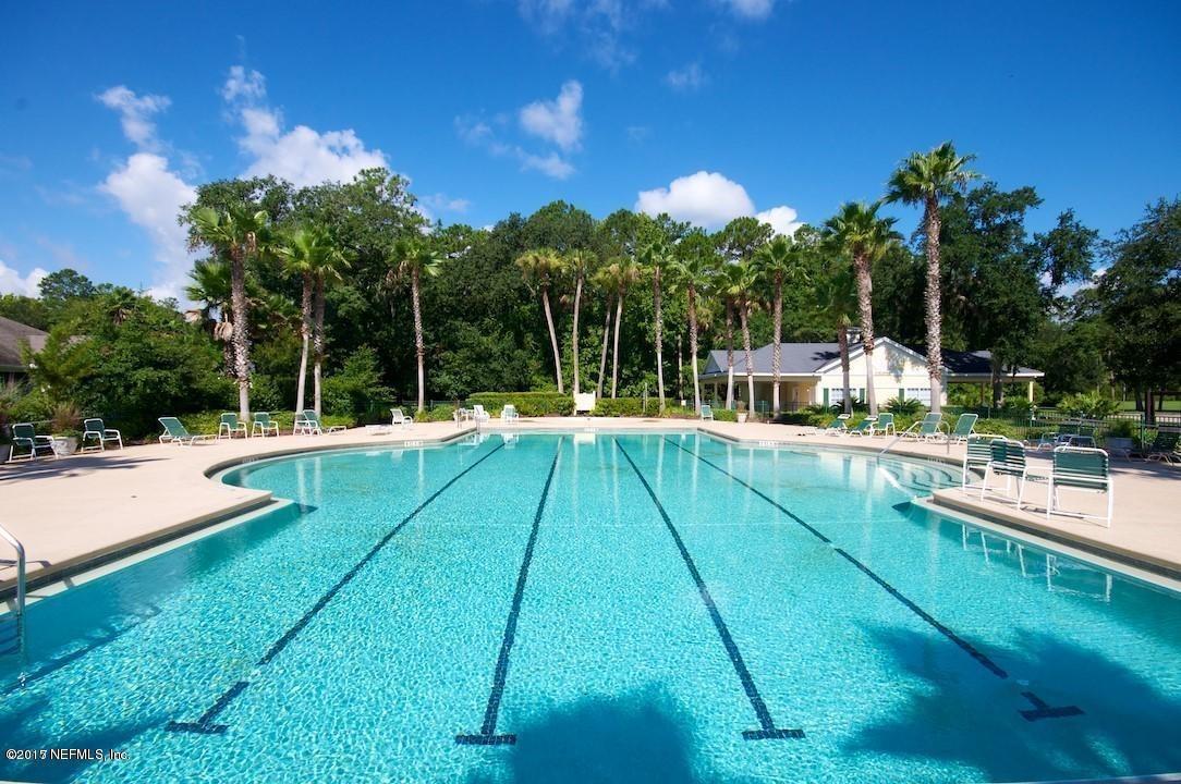 261 North Mill View Way Ponte Vedra Beach, FL 32082 - Photo 27 of 27 a view of a swimming pool with a yard and palm trees