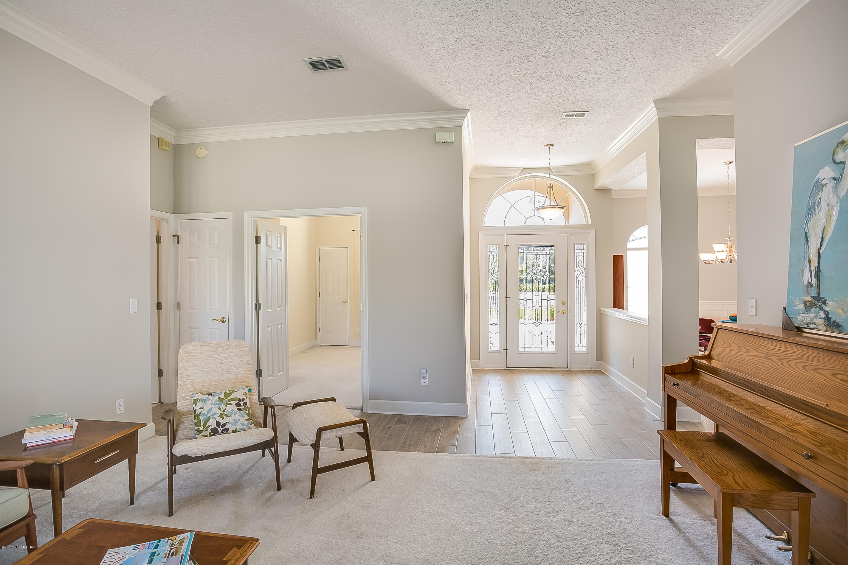 261 North Mill View Way Ponte Vedra Beach, FL 32082 - Photo 5 of 27 a living room with furniture and a chandelier