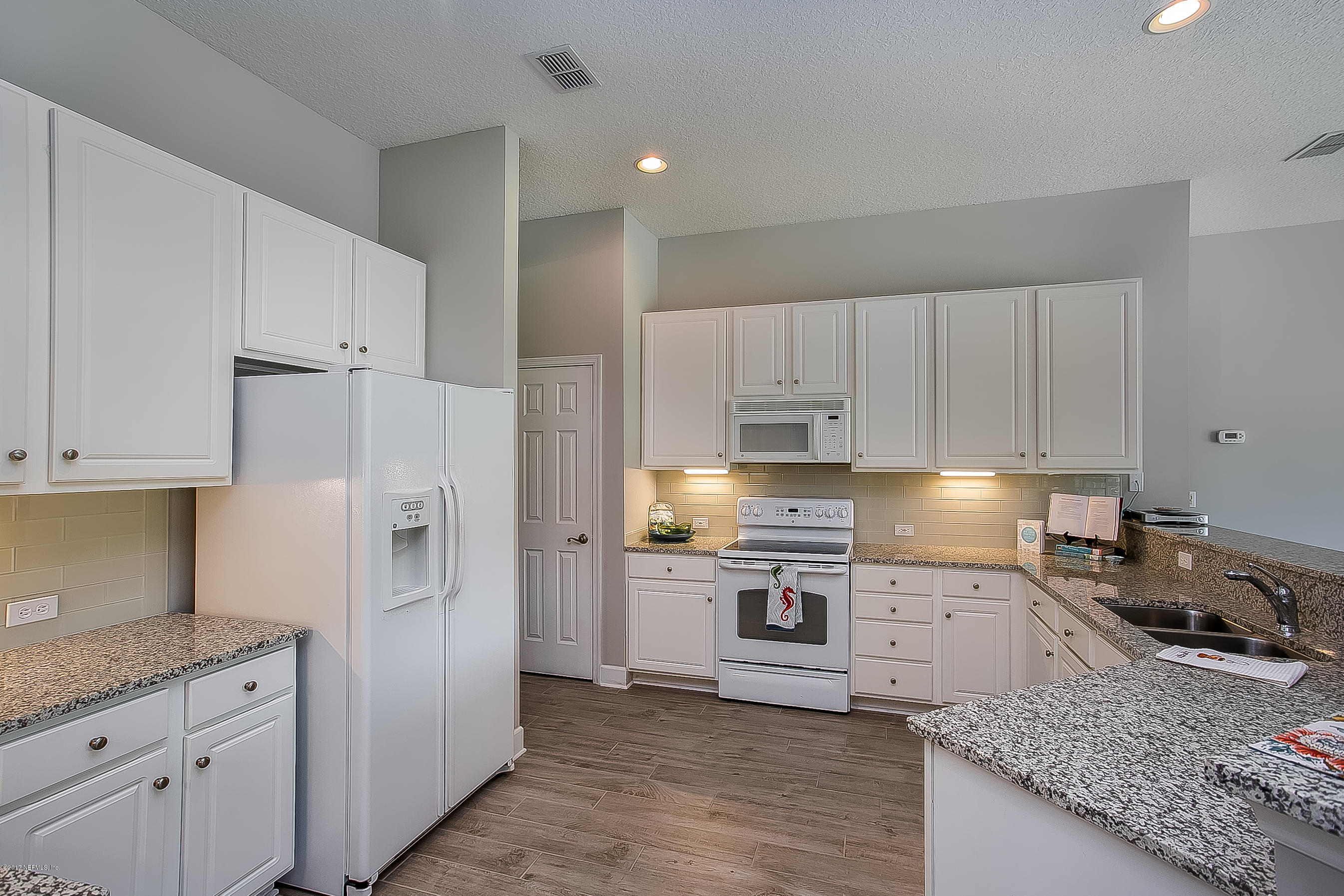 261 North Mill View Way Ponte Vedra Beach, FL 32082 - Photo 6 of 27 a kitchen with granite countertop a refrigerator stove and sink
