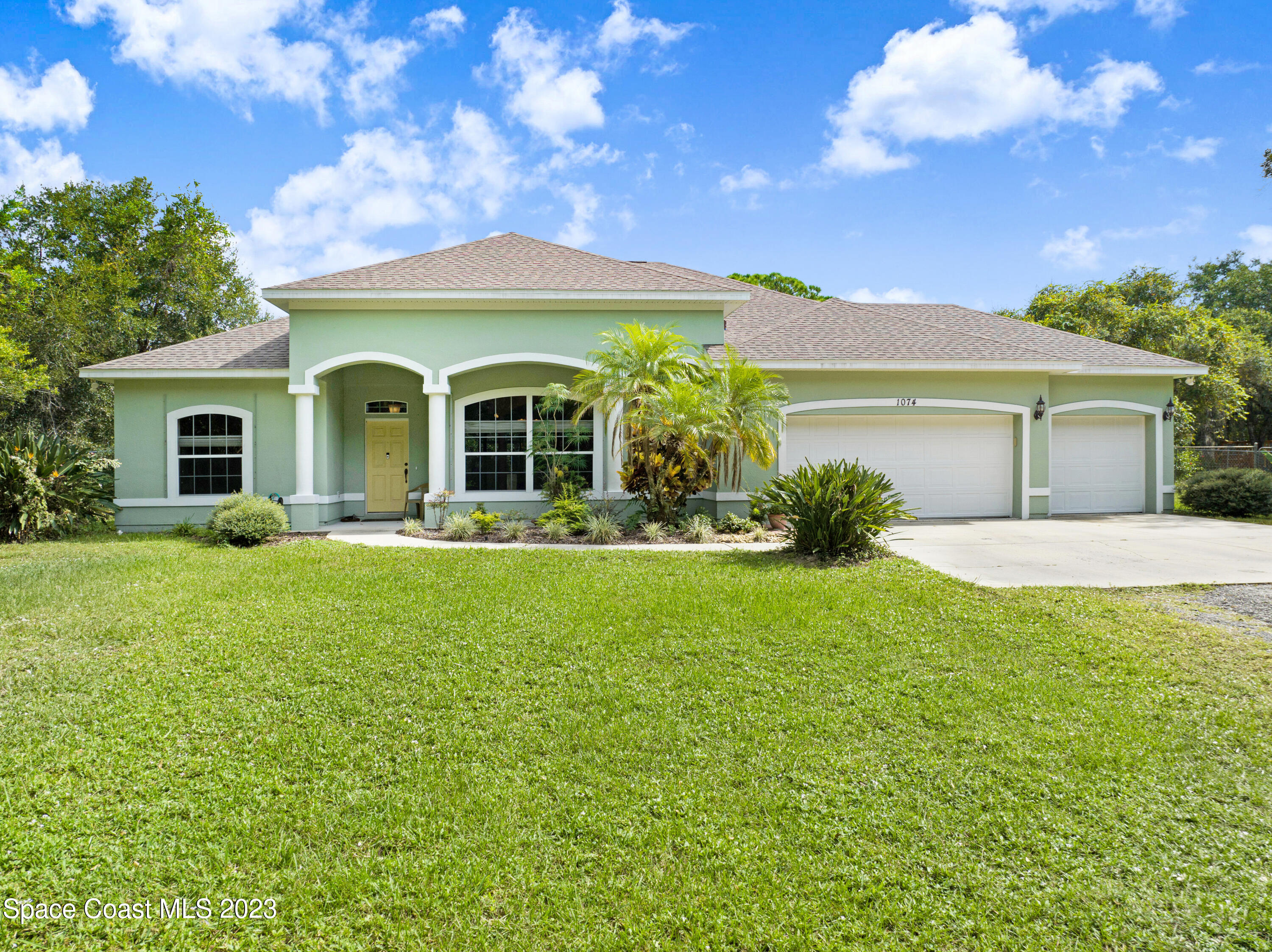 1074 Gray Road Cocoa, FL 32926 - Photo 1 of 47 a front view of a house with garden