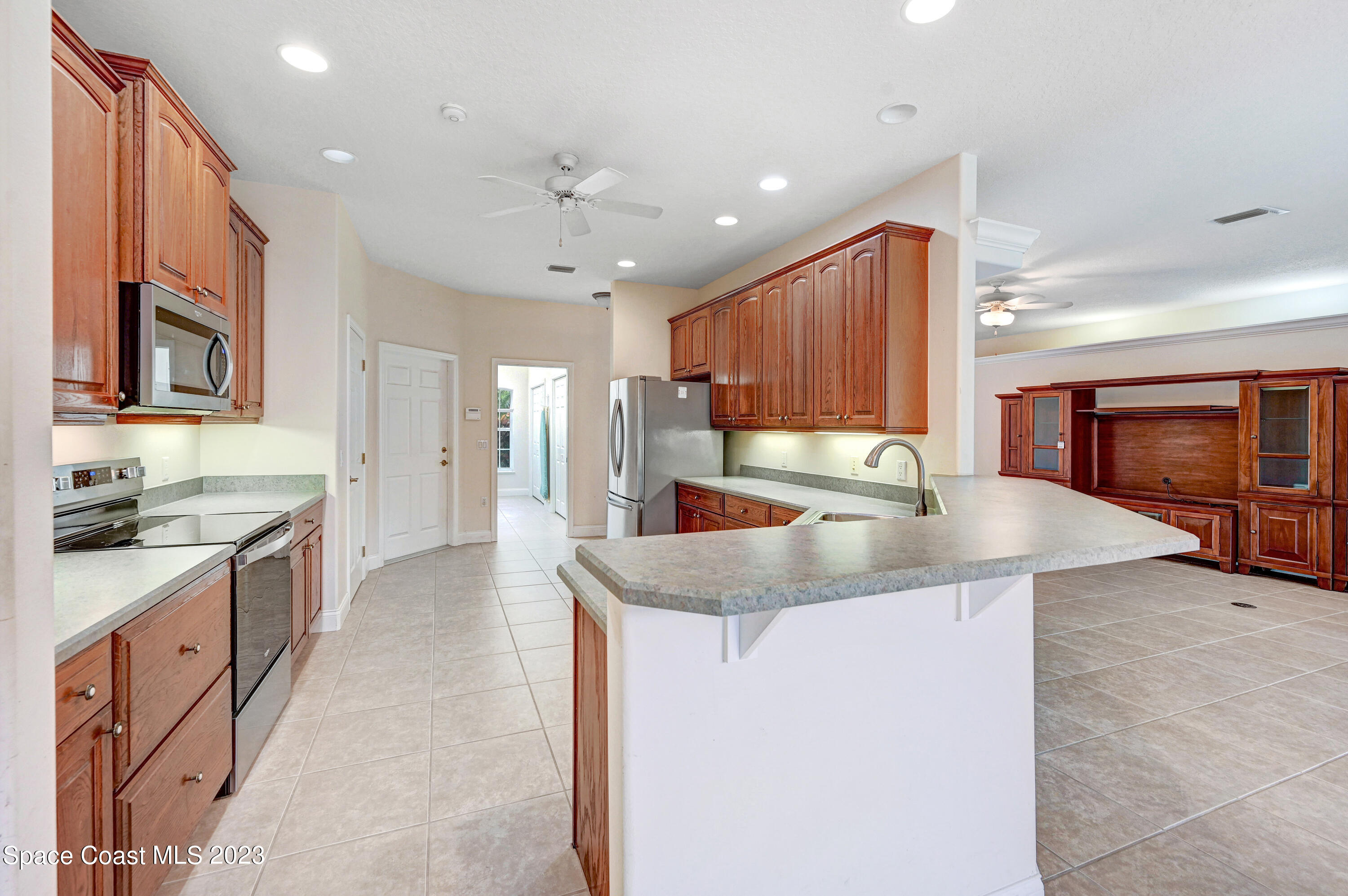 1074 Gray Road Cocoa, FL 32926 - Photo 17 of 47 a kitchen with stainless steel appliances granite countertop a sink a stove and a refrigerator