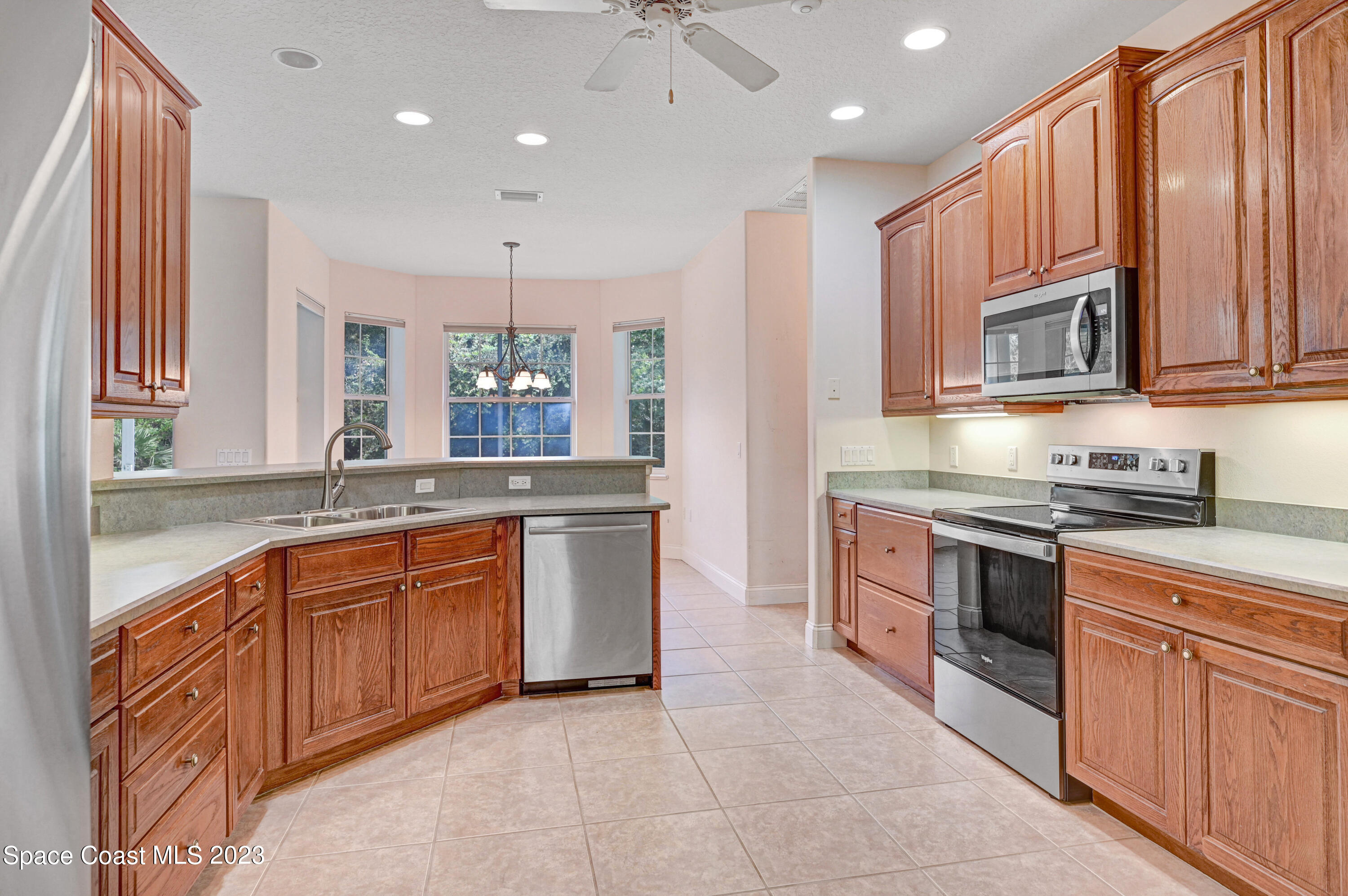 1074 Gray Road Cocoa, FL 32926 - Photo 20 of 47 a large kitchen with stainless steel appliances granite countertop a stove sink and cabinets