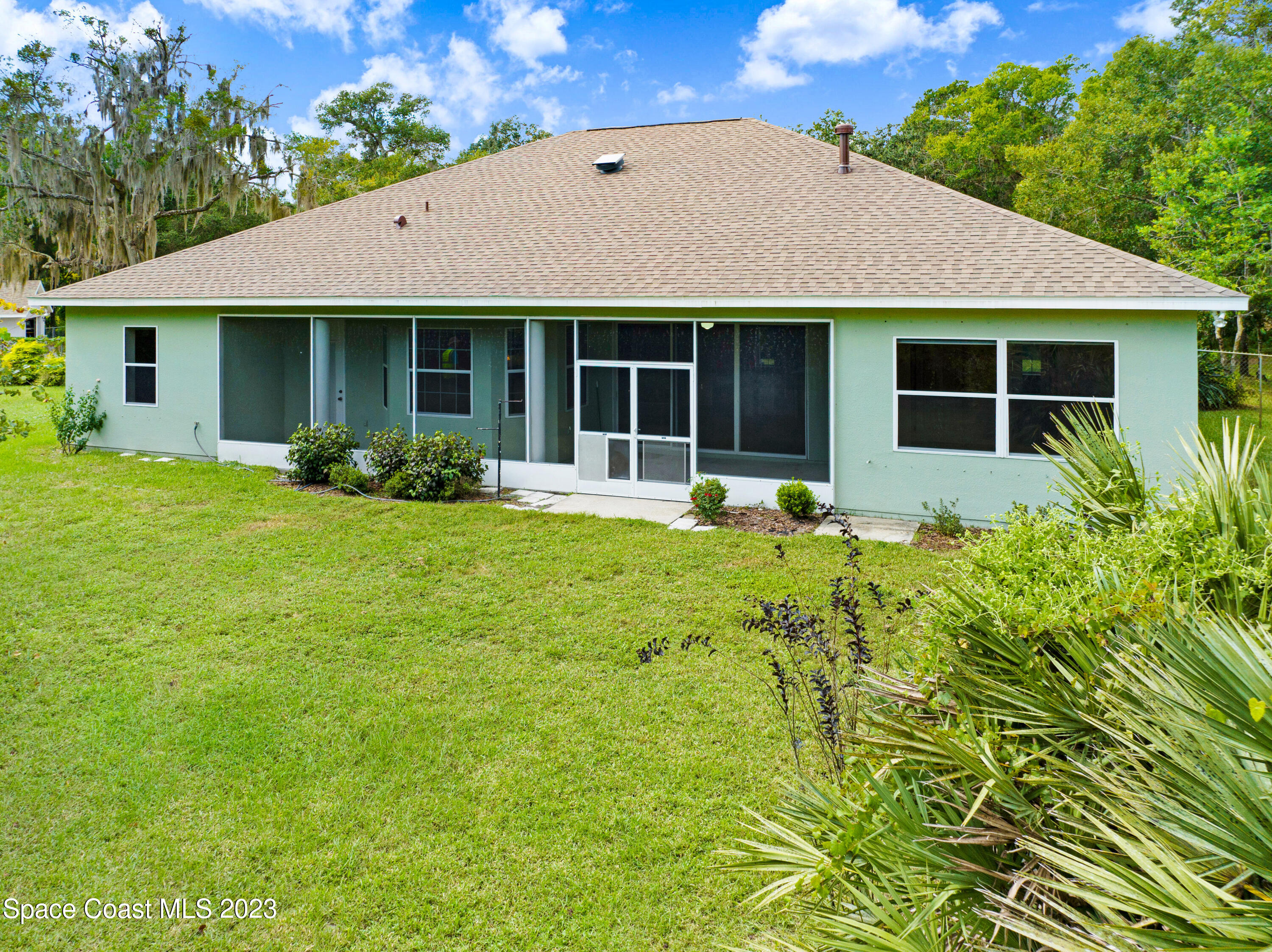 1074 Gray Road Cocoa, FL 32926 - Photo 3 of 47 a front view of a house with a garden and porch
