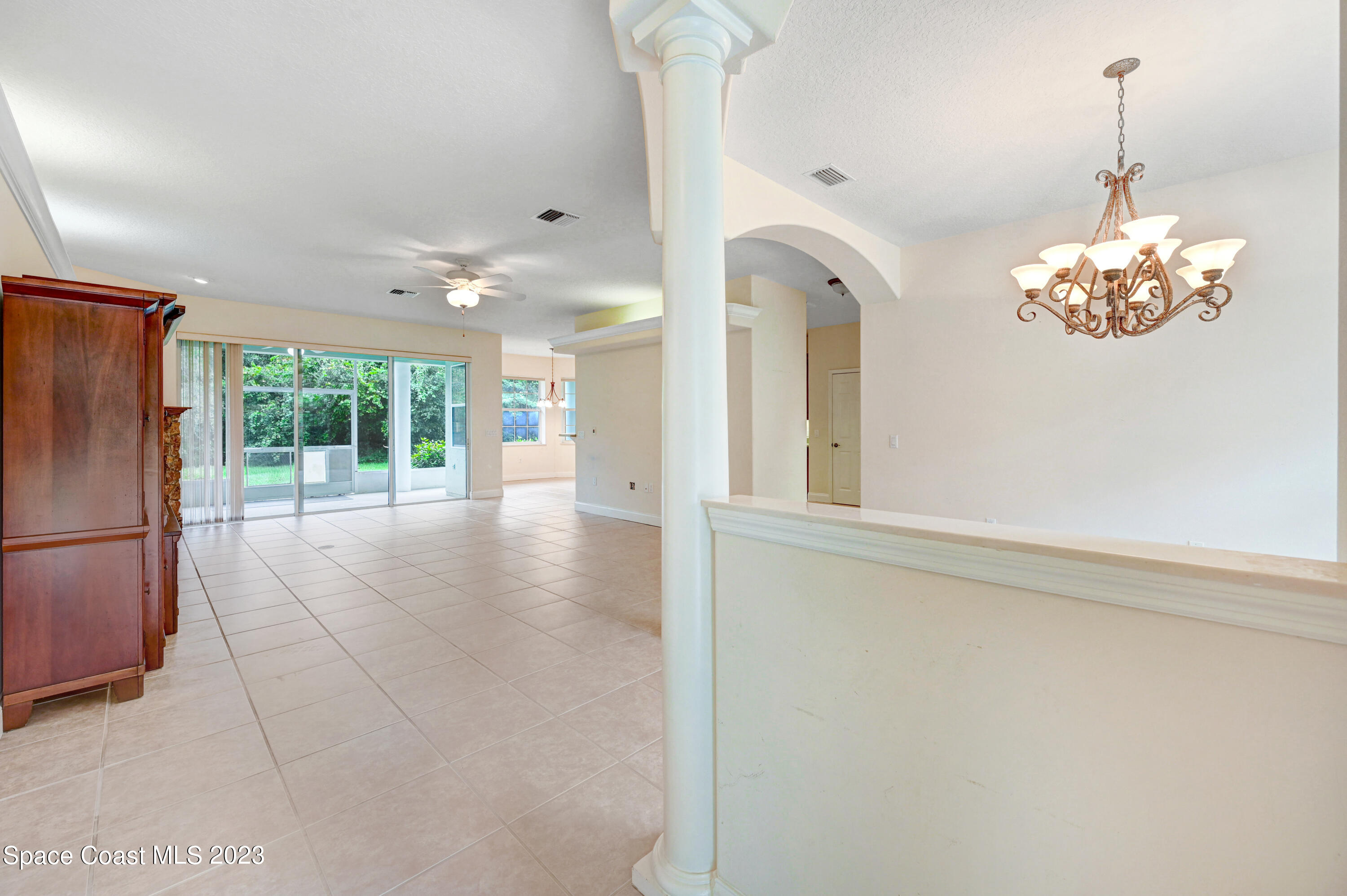 1074 Gray Road Cocoa, FL 32926 - Photo 9 of 47 a view of a hallway with chandelier