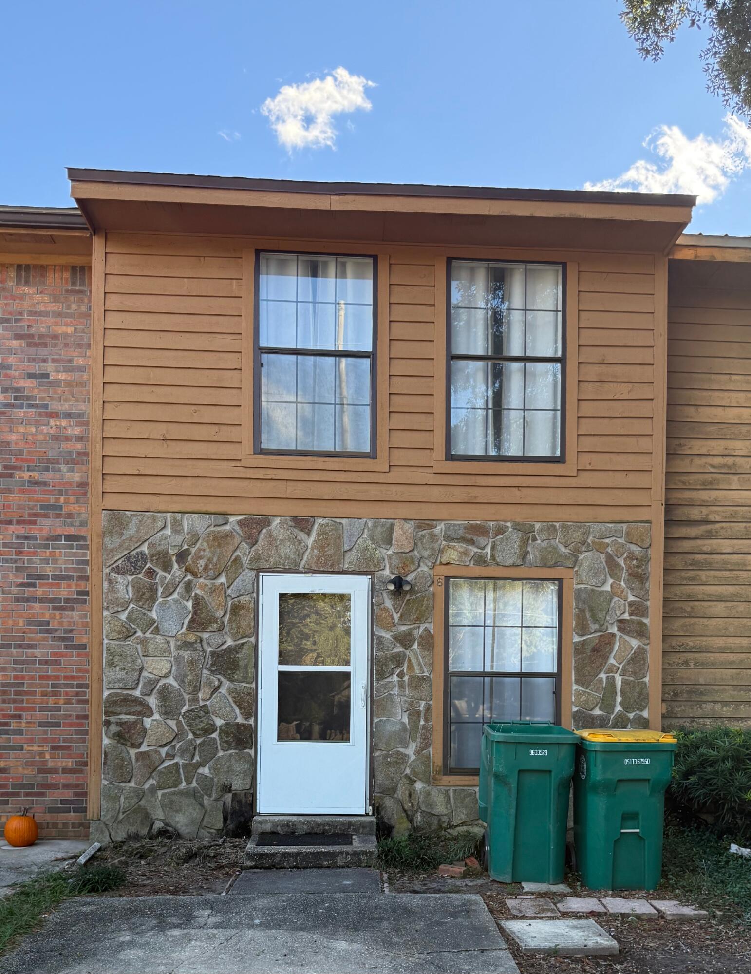 a front view of a house with a garden