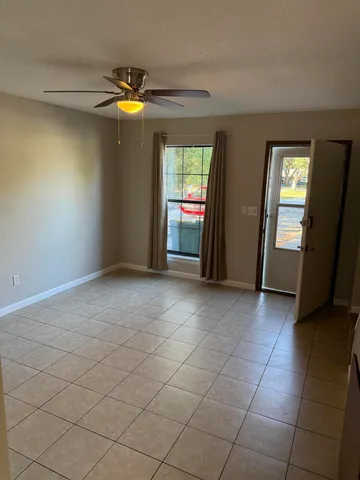 a view of a livingroom with an empty space and a window