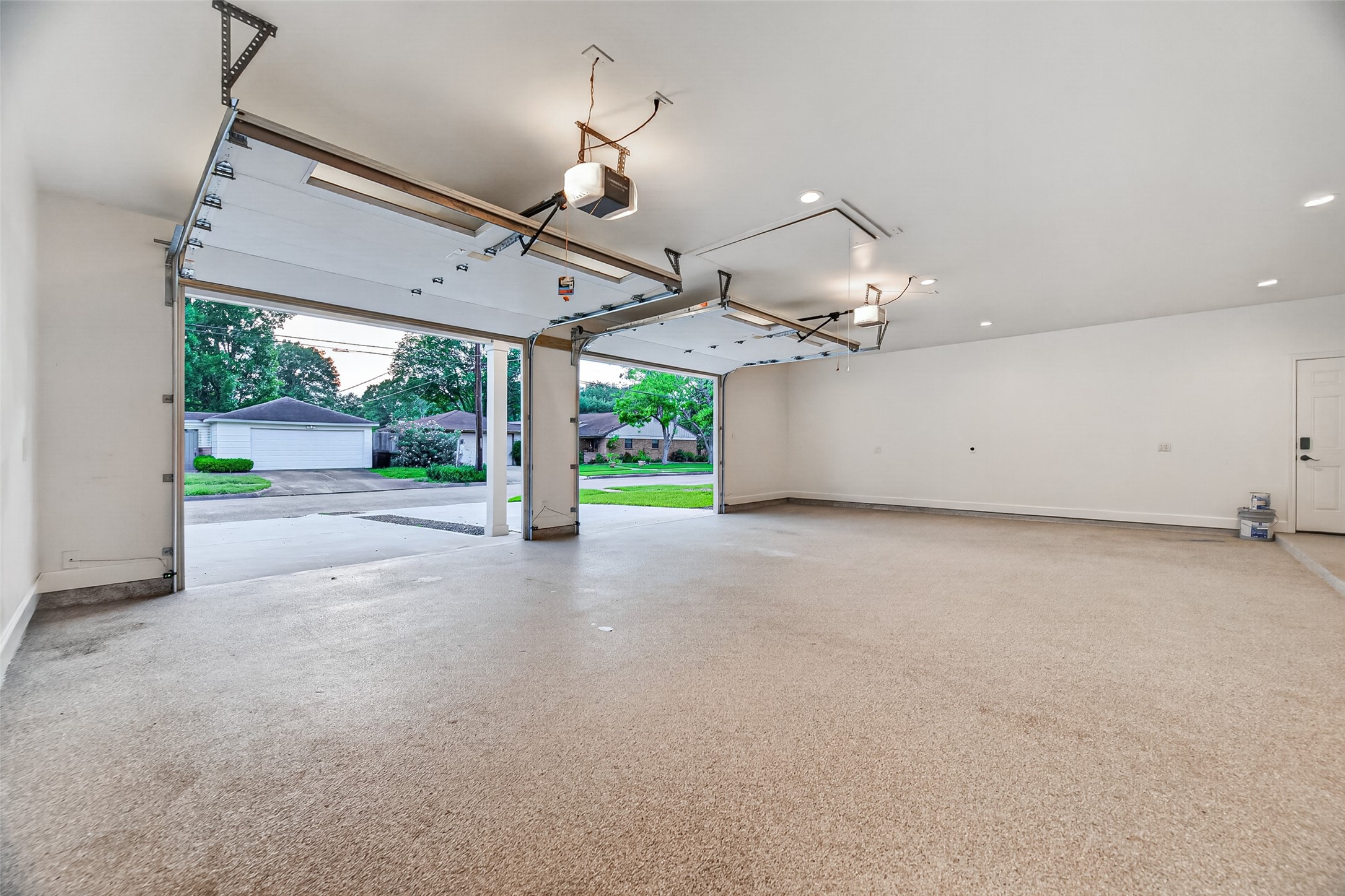 5638 Sanford Road Houston, TX 77096 - Photo 33 of 41 Insulated 12-ft garage doors are equipped with Chamberlain openers and MyQ app integration for convenient, remote access and control.