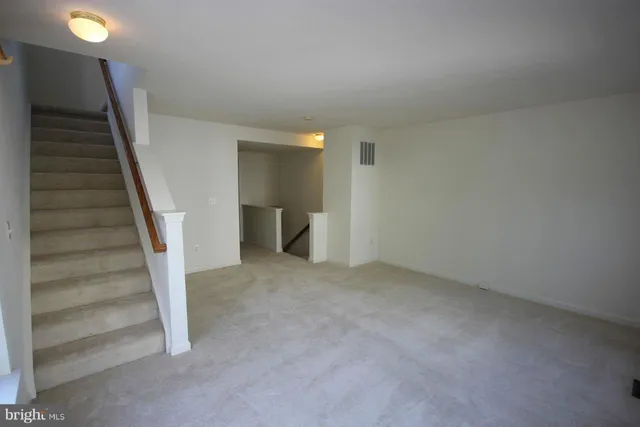 a view of an empty room with stairs