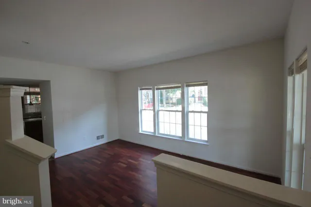 a room with a window and wooden floor