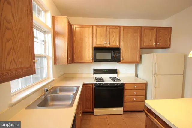 a kitchen with a sink a stove and a microwave