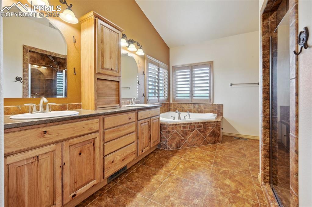 1625 North Yoder Road Yoder, CO 80864 - Photo 19 of 50 a spacious bathroom with a granite countertop tub sink and mirror
