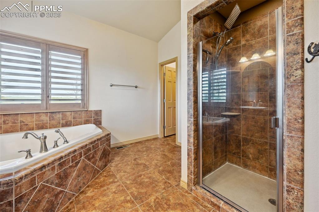 1625 North Yoder Road Yoder, CO 80864 - Photo 20 of 50 a bathroom with a bathtub and a shower