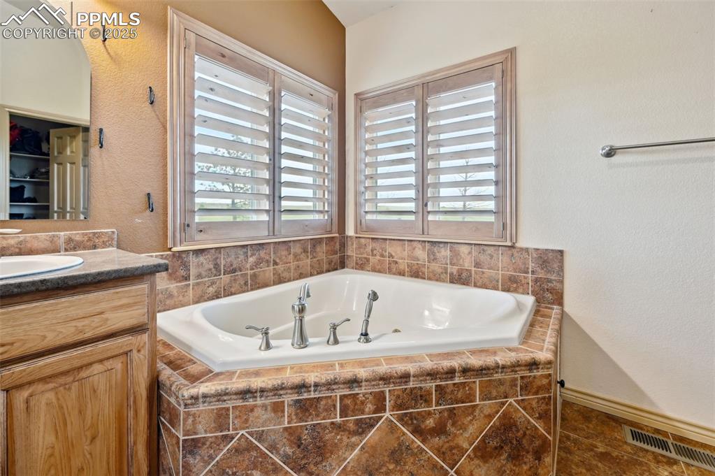 1625 North Yoder Road Yoder, CO 80864 - Photo 21 of 50 a bath tub sitting in a bathroom next to a window