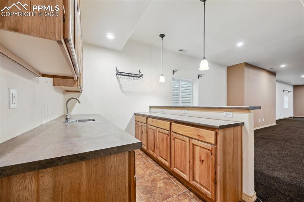 1625 North Yoder Road Yoder, CO 80864 - Photo 30 of 50 a kitchen with stainless steel appliances granite countertop a sink a stove and a wooden floors